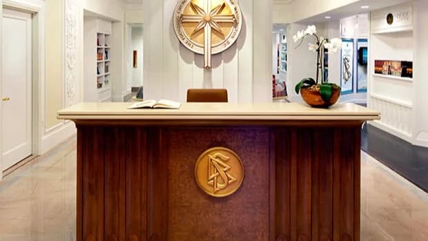 The reception desk of the Founding Church of Scientology of Washington, DC, with the church’s seal mounted on the wall behind it.